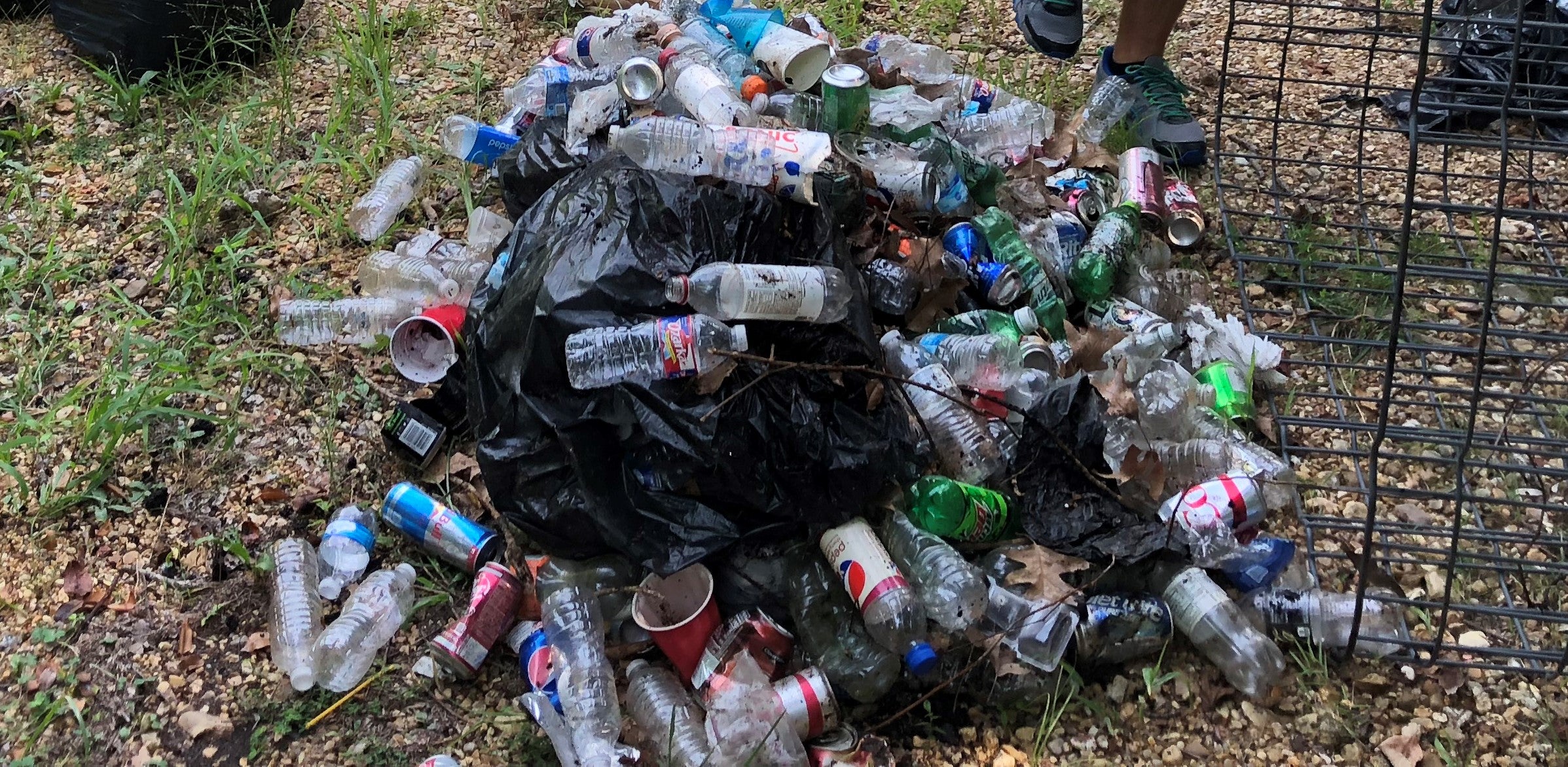 Large pile of plastic and aluminum items laying in a pile on the ground 